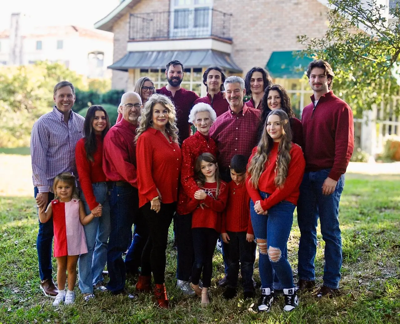 Renée Helmer with her extended family, gathered outside for a group portrait